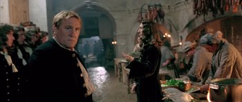 Movie still from “Vatel” (2000), directed by Roland Joffé – Two men in medieval garb standing in a room; Medium shot, Over the shoulder angle