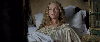 Movie still from “Vatel” (2000), directed by Roland Joffé – A woman with long blonde curly hair sitting on a couch; Medium shot, High angle