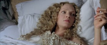 Movie still from “Vatel” (2000), directed by Roland Joffé – A person laying on a bed with curly blonde hair; Close Up shot, Overhead angle