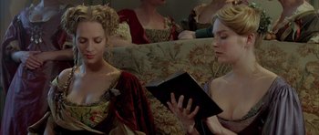 Movie still from “Vatel” (2000), directed by Roland Joffé – A group of women sitting on a couch reading a book; Medium shot, High angle