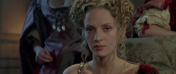 Movie still from “Vatel” (2000), directed by Roland Joffé – A person with curly blonde hair; Close Up shot, Over the shoulder angle