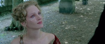 Movie still from “Vatel” (2000), directed by Roland Joffé – A beautiful woman in a red dress looking at the camera; Close Up shot, Over the shoulder angle