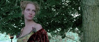 Movie still from “Vatel” (2000), directed by Roland Joffé – A woman with a tattoo on her arm standing in front of a tree; Close Up shot, Low angle