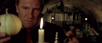 Movie still from “Vatel” (2000), directed by Roland Joffé – A man is looking at a lit candle in the dark; Close Up shot, Low angle