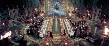 Movie still from “Vatel” (2000), directed by Roland Joffé – People are gathered around a banquet table in a theater; Extreme Wide shot, High angle