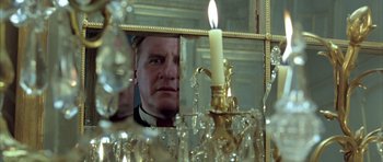 Movie still from “Vatel” (2000), directed by Roland Joffé – A man looking at himself in a mirror with a lit candle; Close Up shot, Low angle