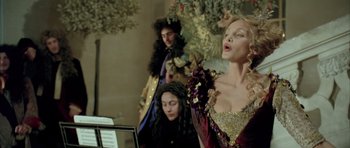 Movie still from “Vatel” (2000), directed by Roland Joffé – A woman is singing in front of two other people; Medium shot, Low angle