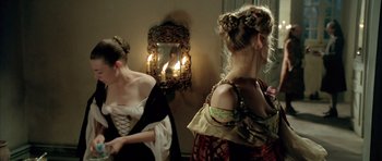 Movie still from “Vatel” (2000), directed by Roland Joffé – Two women dressed in period clothing in front of a mirror; Medium shot, Over the shoulder angle