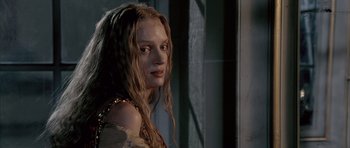 Movie still from “Vatel” (2000), directed by Roland Joffé – A woman with long hair and a gold necklace; Close Up shot, Over the shoulder angle