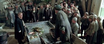 Movie still from “Vatel” (2000), directed by Roland Joffé – An old man standing in front of a bunch of people; Wide shot, High angle