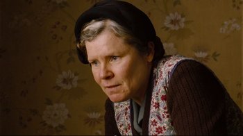 Movie still from “Vera Drake” (2004), directed by Mike Leigh – An older woman wearing a hat and a scarf; Close Up shot, Low angle