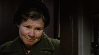 Movie still from “Vera Drake” (2004), directed by Mike Leigh – An older woman wearing a green coat and a hat; Close Up shot, Low angle