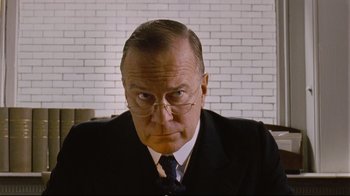 Movie still from “Vera Drake” (2004), directed by Mike Leigh – An older man wearing a suit and tie; Close Up shot, Low angle