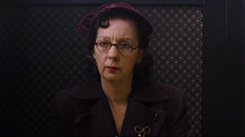 Movie still from “Vera Drake” (2004), directed by Mike Leigh – An older woman wearing glasses and a hat; Close Up shot, Low angle