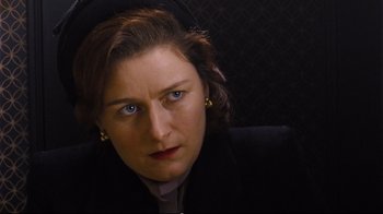 Movie still from “Vera Drake” (2004), directed by Mike Leigh – A person wearing a suit; Close Up shot, High angle