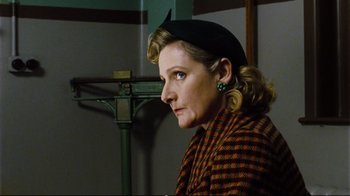 Movie still from “Vera Drake” (2004), directed by Mike Leigh – A woman wearing a hat and a plaid jacket; Close Up shot, Low angle