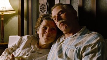 Movie still from “Vera Drake” (2004), directed by Mike Leigh – An older man and a younger woman posing for a picture; Close Up shot, Low angle