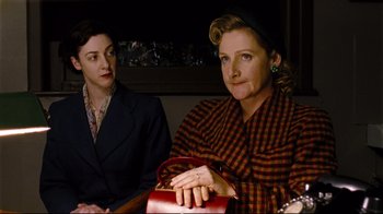 Movie still from “Vera Drake” (2004), directed by Mike Leigh – Two women sitting next to each other on a bench; Medium shot, High angle