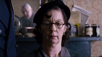 Movie still from “Vera Drake” (2004), directed by Mike Leigh – An older woman wearing glasses and a hat; Close Up shot, Low angle