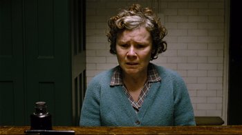 Movie still from “Vera Drake” (2004), directed by Mike Leigh – An older woman sitting in front of a table; Close Up shot, High angle