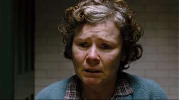 Movie still from “Vera Drake” (2004), directed by Mike Leigh – An older woman with curly grey hair is crying; Close Up shot, Low angle