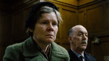 Movie still from “Vera Drake” (2004), directed by Mike Leigh – An older woman and a man in a courtroom; Close Up shot, Low angle