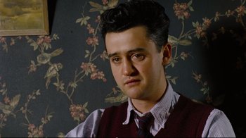 Movie still from “Vera Drake” (2004), directed by Mike Leigh – A young man in a vest and a tie; Close Up shot, Low angle