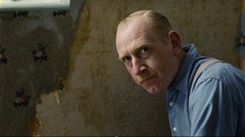 Movie still from “Vera Drake” (2004), directed by Mike Leigh – A man in a blue shirt is looking at the camera; Close Up shot, Low angle