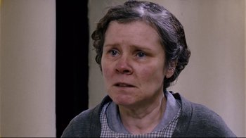 Movie still from “Vera Drake” (2004), directed by Mike Leigh – An older woman with a frowning look on her face; Close Up shot, Low angle