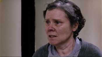 Movie still from “Vera Drake” (2004), directed by Mike Leigh – An older woman with a sad look on her face; Close Up shot, Over the shoulder angle