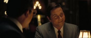 Movie still from “Vice” (2018), directed by Adam McKay – A man wearing a suit and tie sitting at a table; Close Up shot, Over the shoulder angle