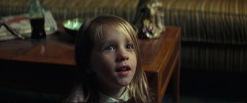 Movie still from “Vice” (2018), directed by Adam McKay – A little girl sitting at a table looking up; Close Up shot, High angle