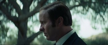 Movie still from “Vice” (2018), directed by Adam McKay – A person wearing a suit and tie; Close Up shot, Low angle