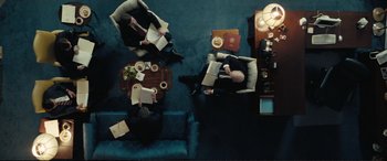 Movie still from “Vice” (2018), directed by Adam McKay – A group of people sitting on a blue couch; Wide shot, Overhead angle