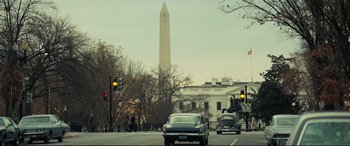 Movie still from “Vice” (2018), directed by Adam McKay – Cars driving down the street in front of the washington monument; Extreme Wide shot, Low angle