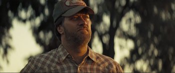 Movie still from “Vice” (2018), directed by Adam McKay – A man with a beard wearing a hat and a plaid shirt; Close Up shot, Low angle
