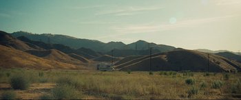 Movie still from “Vice” (2018), directed by Adam McKay – An rv parked in the middle of a grassy field; Extreme Wide shot, High angle