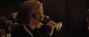 Movie still from “Vice” (2018), directed by Adam McKay – A woman drinking a glass of red wine from a wine glass; Close Up shot, Low angle