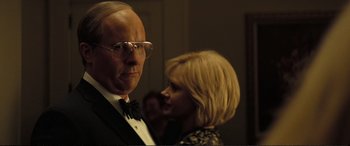 Movie still from “Vice” (2018), directed by Adam McKay – A man and a woman standing next to each other in a room; Close Up shot, Over the shoulder angle