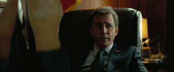 Movie still from “Vice” (2018), directed by Adam McKay – A person wearing a suit and tie; Close Up shot, Over the shoulder angle
