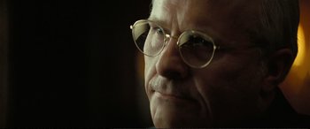 Movie still from “Vice” (2018), directed by Adam McKay – An older man wearing glasses looking at the camera; Close Up shot, Low angle