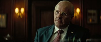 Movie still from “Vice” (2018), directed by Adam McKay – An older man wearing a suit and tie; Close Up shot, Over the shoulder angle