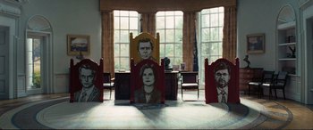 Movie still from “Vice” (2018), directed by Adam McKay – A room filled with chairs and a desk; Wide shot, Low angle