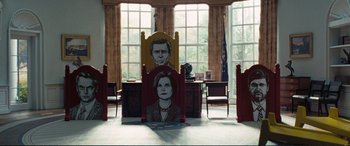 Movie still from “Vice” (2018), directed by Adam McKay – A painting of a man and a woman in a room; Wide shot, Low angle