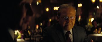 Movie still from “Vice” (2018), directed by Adam McKay – An older man in a suit and sunglasses; Close Up shot, Over the shoulder angle