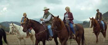 Movie still from “Vice” (2018), directed by Adam McKay – A man and a woman are riding on horses; Medium shot, Low angle
