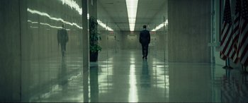 Movie still from “Vice” (2018), directed by Adam McKay – A man in a suit walking down a hallway; Wide shot, Low angle