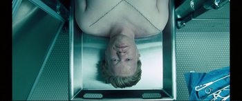 Movie still from “Vice” (2018), directed by Adam McKay – A man is laying down in an open box; Close Up shot, Overhead angle