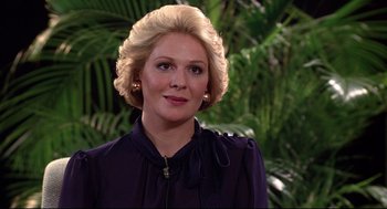 Movie still from “Videodrome” (1983), directed by David Cronenberg – A person with blonde hair; Close Up shot, Over the shoulder angle