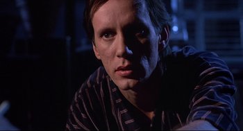 Movie still from “Videodrome” (1983), directed by David Cronenberg – A person wearing a striped shirt; Close Up shot, Low angle